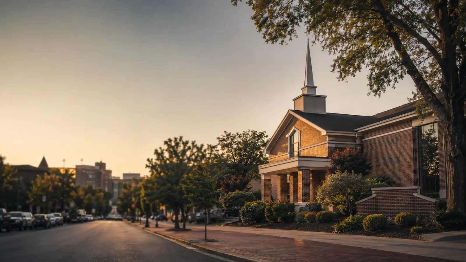 A Church of Christ building on a downtown street at dusk